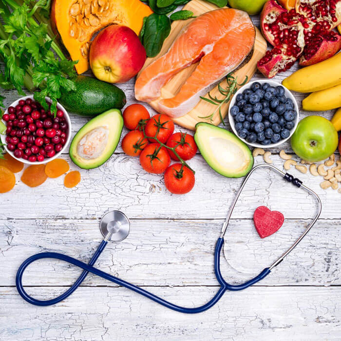 table with healthy fruits and stethoscope