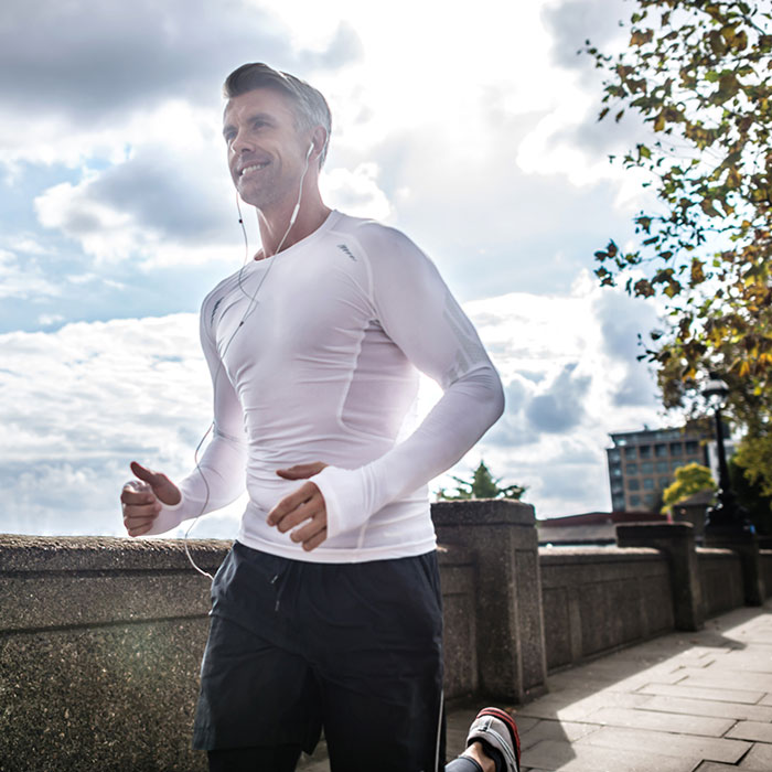 man jogging along bridge